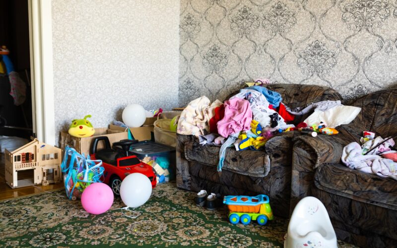 A mess in the room. A lot of things are lying around the apartment. House is in the room